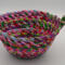 This view is looking at the fabric bowl from the side, showing all the colors of fabric scraps and another view of the knot.